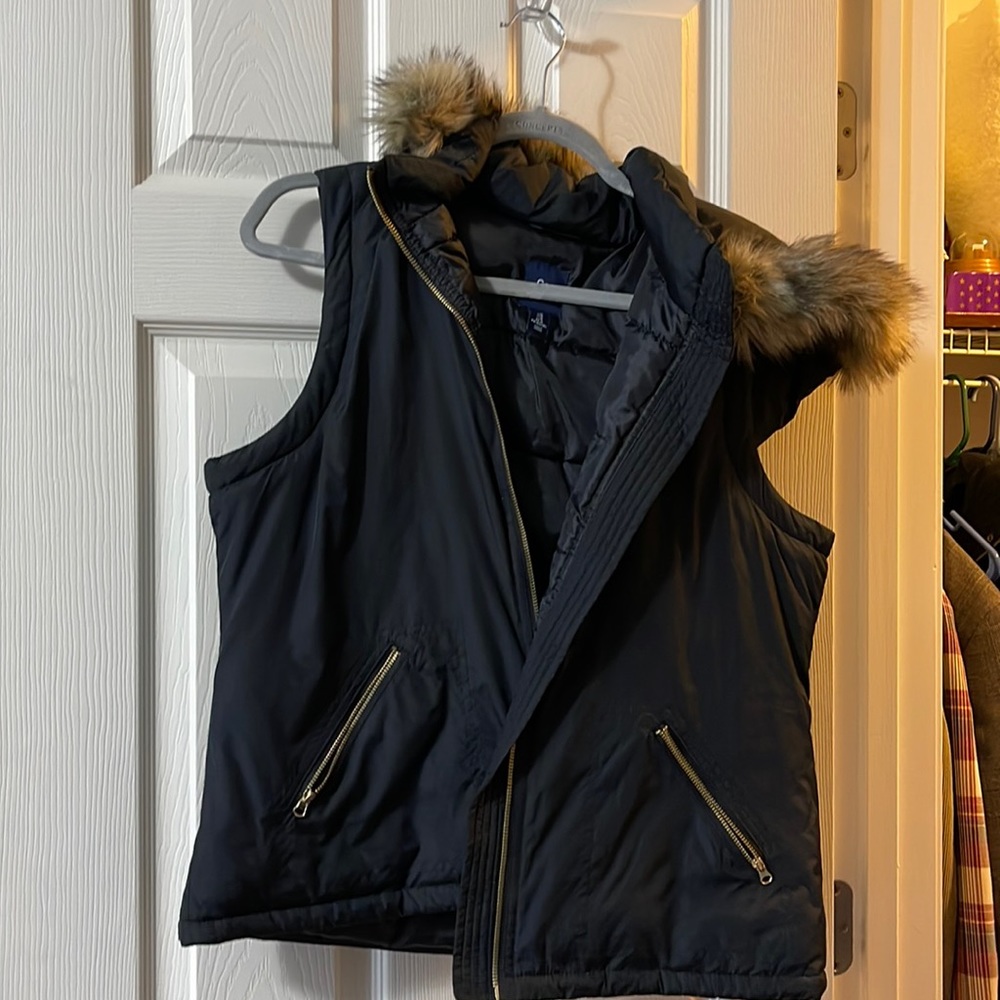Fur edged hood, black vest